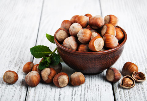 Bowl with hazelnuts on a old wooden table