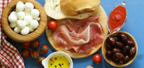 Italian food - olives, parma ham, tomatoes, mozzarella cheese